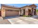 Charming home featuring a spacious driveway, stone accents, and a two-car garage at 3285 E Phelps St, Gilbert, AZ 85295