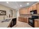 Bright kitchen featuring granite countertops, stainless steel appliances, oak cabinets and tile flooring at 3285 E Phelps St, Gilbert, AZ 85295