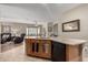 Open concept kitchen with breakfast bar and view into adjacent living and dining areas with neutral color palette at 3285 E Phelps St, Gilbert, AZ 85295