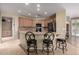 Kitchen with granite countertops, tile floors, oak cabinets, a breakfast bar with stools, and stainless steel appliances at 3285 E Phelps St, Gilbert, AZ 85295