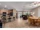 Open concept living space with kitchen and living room featuring tile and hardwood flooring, and lots of seating at 3285 E Phelps St, Gilbert, AZ 85295