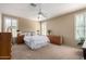 Spacious main bedroom with a ceiling fan, shuttered windows, and elegant furnishings, providing a peaceful retreat at 3285 E Phelps St, Gilbert, AZ 85295