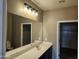Bright bathroom with large mirror, vanity with sink, and modern lighting at 36905 W Mattino Ln, Maricopa, AZ 85138