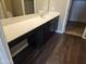 Modern bathroom features a large vanity with a sink, ample counter space, and dark wood cabinets at 36905 W Mattino Ln, Maricopa, AZ 85138