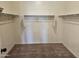 Spacious walk-in closet with built-in shelving and ample storage space for clothes and accessories at 36905 W Mattino Ln, Maricopa, AZ 85138