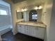 Double vanity bathroom with updated cabinets and countertops, and an adjacent full bathroom at 3758 E Ironwood Dr, Phoenix, AZ 85044