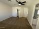 Spacious bedroom featuring neutral walls, a ceiling fan, closet, and an ensuite bath at 3758 E Ironwood Dr, Phoenix, AZ 85044