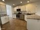 Updated kitchen boasting stainless steel appliances, granite countertops, and white cabinets at 3758 E Ironwood Dr, Phoenix, AZ 85044