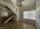 Open-concept living room featuring a staircase and large windows at 3758 E Ironwood Dr, Phoenix, AZ 85044