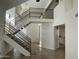 Bright, naturally lit foyer with a view of the staircase and modern railing at 3758 E Ironwood Dr, Phoenix, AZ 85044