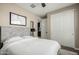 Bedroom with white walls, a king bed, and large closet with sliding doors at 37783 W San Sisto Ave, Maricopa, AZ 85138