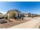 Lovely home featuring low maintenance landscaping, a two car garage, and a beautiful blue sky at 37783 W San Sisto Ave, Maricopa, AZ 85138