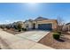Inviting single-story home with a spacious driveway and low maintenance landscaping at 37783 W San Sisto Ave, Maricopa, AZ 85138