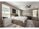 Spacious main bedroom with large bed with storage, ceiling fan, and lots of natural light at 37783 W San Sisto Ave, Maricopa, AZ 85138
