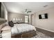 Main bedroom featuring a king bed, neutral walls, and a flat-screen TV at 37783 W San Sisto Ave, Maricopa, AZ 85138
