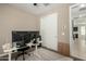 Home office featuring a sliding door, dual monitors, and nearby closet at 37783 W San Sisto Ave, Maricopa, AZ 85138