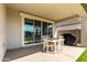 Outdoor covered patio with a dining table and chairs, and a sliding glass door at 37783 W San Sisto Ave, Maricopa, AZ 85138