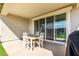 Covered patio area with outdoor table and sliding glass doors to the home's interior at 37783 W San Sisto Ave, Maricopa, AZ 85138