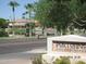 View of Portofino Condominiums with waterfront condos, palm trees, and lush landscaping on a sunny day at 3830 E Lakewood Pkwy # 2085, Phoenix, AZ 85048