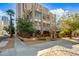 Attractive exterior showcasing a three-story building with red accents, a well-kept yard, and mature trees at 387 N 2Nd Ave # 2E, Phoenix, AZ 85003