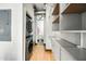 Functional hallway with washer/dryer and shelving, leading to other areas at 387 N 2Nd Ave # 2E, Phoenix, AZ 85003