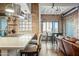 Kitchen and dining area with island, stainless appliances, and brick accent wall at 387 N 2Nd Ave # 2E, Phoenix, AZ 85003