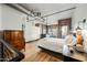 Spacious main bedroom featuring exposed brick, wood floors, and an industrial-style ceiling at 387 N 2Nd Ave # 2E, Phoenix, AZ 85003