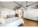 Bright main bedroom featuring hardwood floors, exposed ductwork, and a serene atmosphere at 387 N 2Nd Ave # 2E, Phoenix, AZ 85003