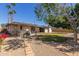 Spacious backyard with hot tub, lush grass, and decorative stone landscaping at 3901 W Davidson Ln, Phoenix, AZ 85051