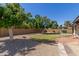 Expansive backyard featuring gravel, turf, and shade trees at 3901 W Davidson Ln, Phoenix, AZ 85051