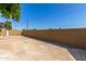 Large concrete backyard, enclosed by a tall brick wall, offering privacy and security at 3901 W Davidson Ln, Phoenix, AZ 85051