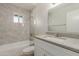 Bathroom features a tub/shower combo, a large mirror, and marble style tile at 3901 W Davidson Ln, Phoenix, AZ 85051