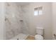 Renovated bathroom with marble tiled shower and updated fixtures at 3901 W Davidson Ln, Phoenix, AZ 85051