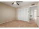 Bedroom with closet, ceiling fan, and carpet floors at 3901 W Davidson Ln, Phoenix, AZ 85051