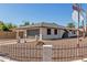 Charming single-story home with a two-car garage, a fenced yard, and desert landscaping at 3901 W Davidson Ln, Phoenix, AZ 85051