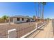 Charming single-story home with a two-car garage, a fenced yard, and desert landscaping at 3901 W Davidson Ln, Phoenix, AZ 85051