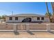 Charming single-story home featuring an arched entryway and low decorative fence at 3901 W Davidson Ln, Phoenix, AZ 85051