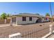 Charming single-story home with side-entry garage, decorative fence, and low maintenance yard at 3901 W Davidson Ln, Phoenix, AZ 85051