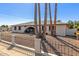 Charming single-story home featuring an arched entryway, mature palms, and low decorative fence at 3901 W Davidson Ln, Phoenix, AZ 85051