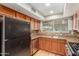 Cozy kitchen with stainless steel appliances, double sink, and laminate backsplash at 3901 W Davidson Ln, Phoenix, AZ 85051