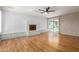 Bright living room with wood floors, a painted brick fireplace, and sliding glass doors to the backyard at 3901 W Davidson Ln, Phoenix, AZ 85051