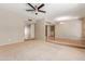 Large, carpeted living room with a ceiling fan and a combined living and dining area at 3901 W Davidson Ln, Phoenix, AZ 85051