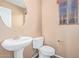 Powder room with a pedestal sink and toilet at 41800 W Chambers Ct, Maricopa, AZ 85138