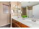 Bathroom featuring dual sinks, a large mirror, and a shower at 41800 W Chambers Ct, Maricopa, AZ 85138