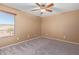 Bedroom with carpet, a ceiling fan, and a view of houses at 41800 W Chambers Ct, Maricopa, AZ 85138