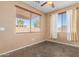 Bright bedroom featuring tiled flooring, neutral walls, window blinds, and custom curtains at 41800 W Chambers Ct, Maricopa, AZ 85138