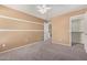 Neutral bedroom featuring a ceiling fan and closet at 41800 W Chambers Ct, Maricopa, AZ 85138