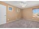 Cozy bedroom with neutral walls, plush carpeting, and a ceiling fan at 41800 W Chambers Ct, Maricopa, AZ 85138