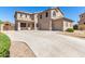 Spacious two-story home with a three-car garage and large concrete driveway, perfect for a growing Gathering at 41800 W Chambers Ct, Maricopa, AZ 85138