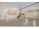 Well-lit garage featuring storage cabinets, work space, and water heater at 41800 W Chambers Ct, Maricopa, AZ 85138